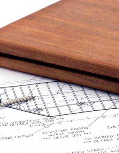 A wooden box sits on top of blueprints.