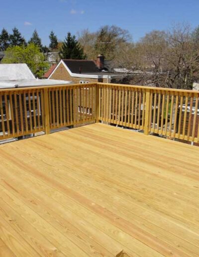 A wooden deck with a railing and railing.
