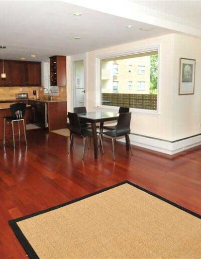 An apartment with hardwood floors and a kitchen.