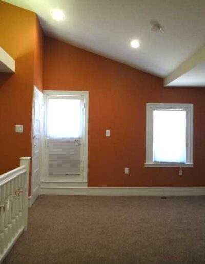 An empty room with orange walls.